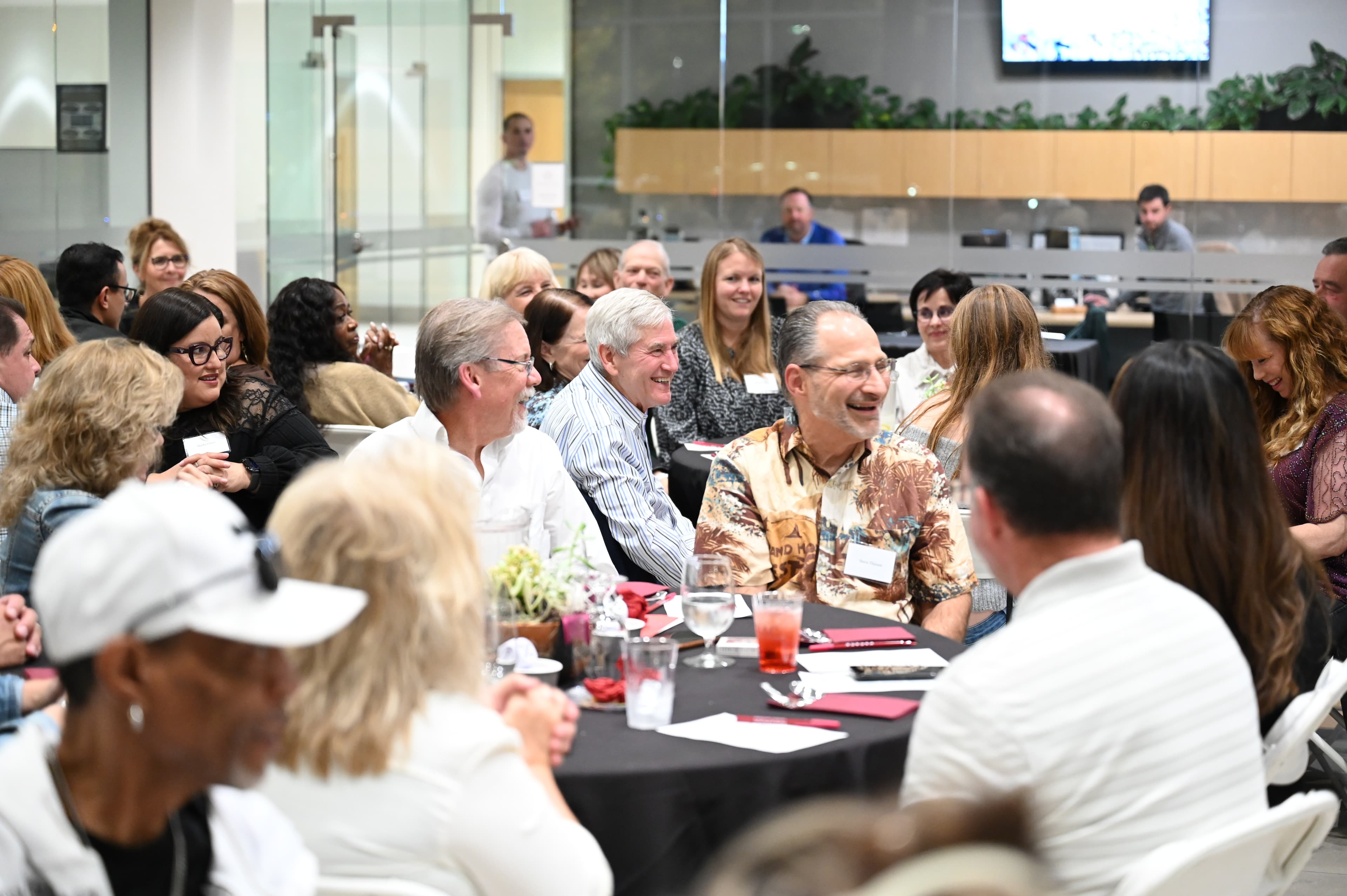 Corporate event attendees networking at table - Stockton event photography