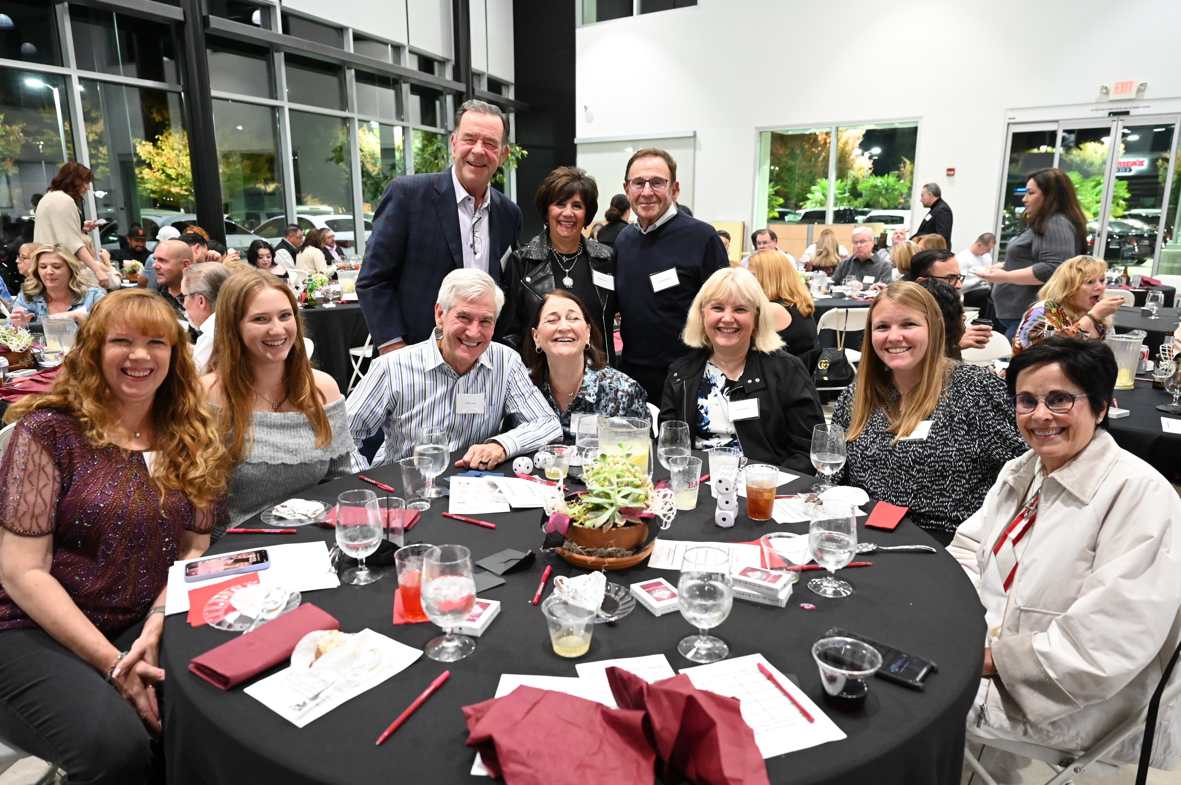 Group photo at corporate event table - professional event photography