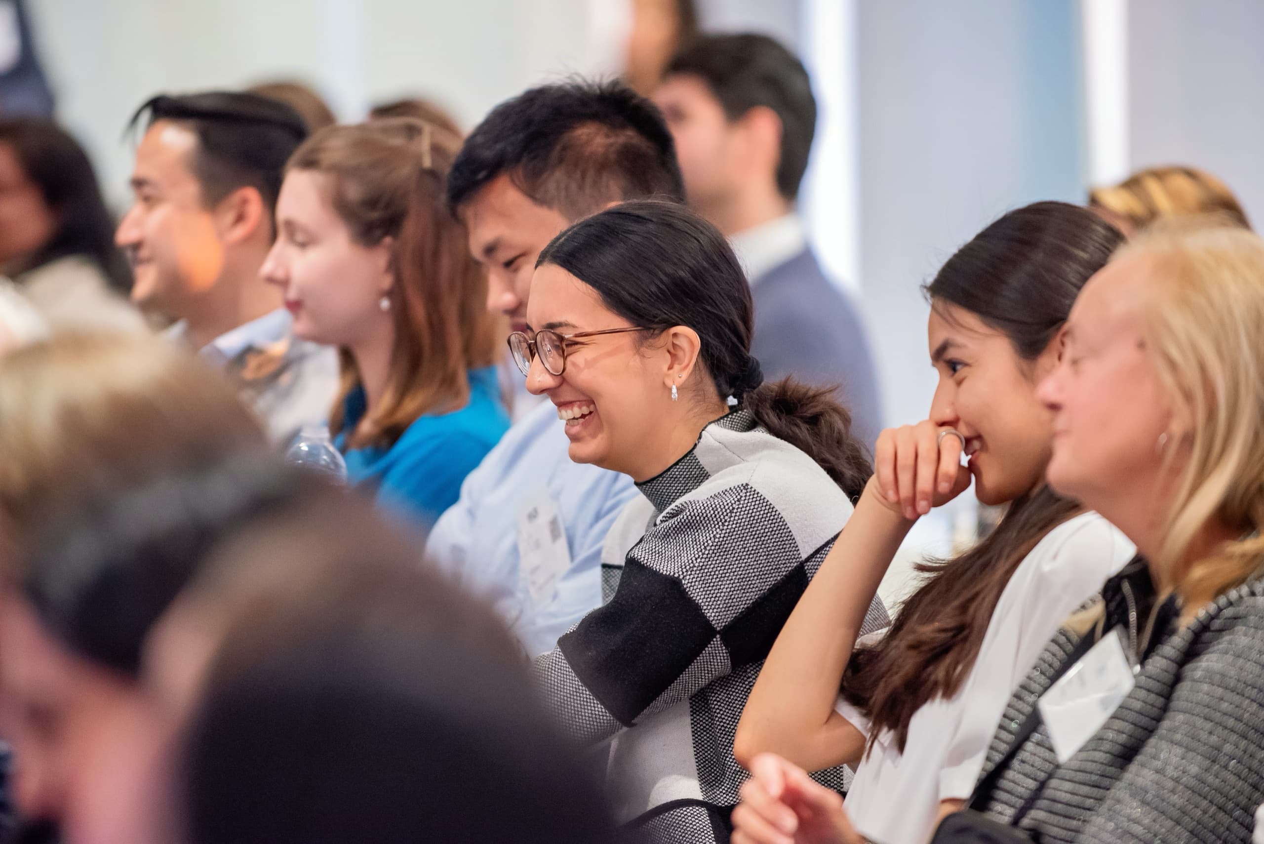 Candid attendee reactions during a conference session — event photography