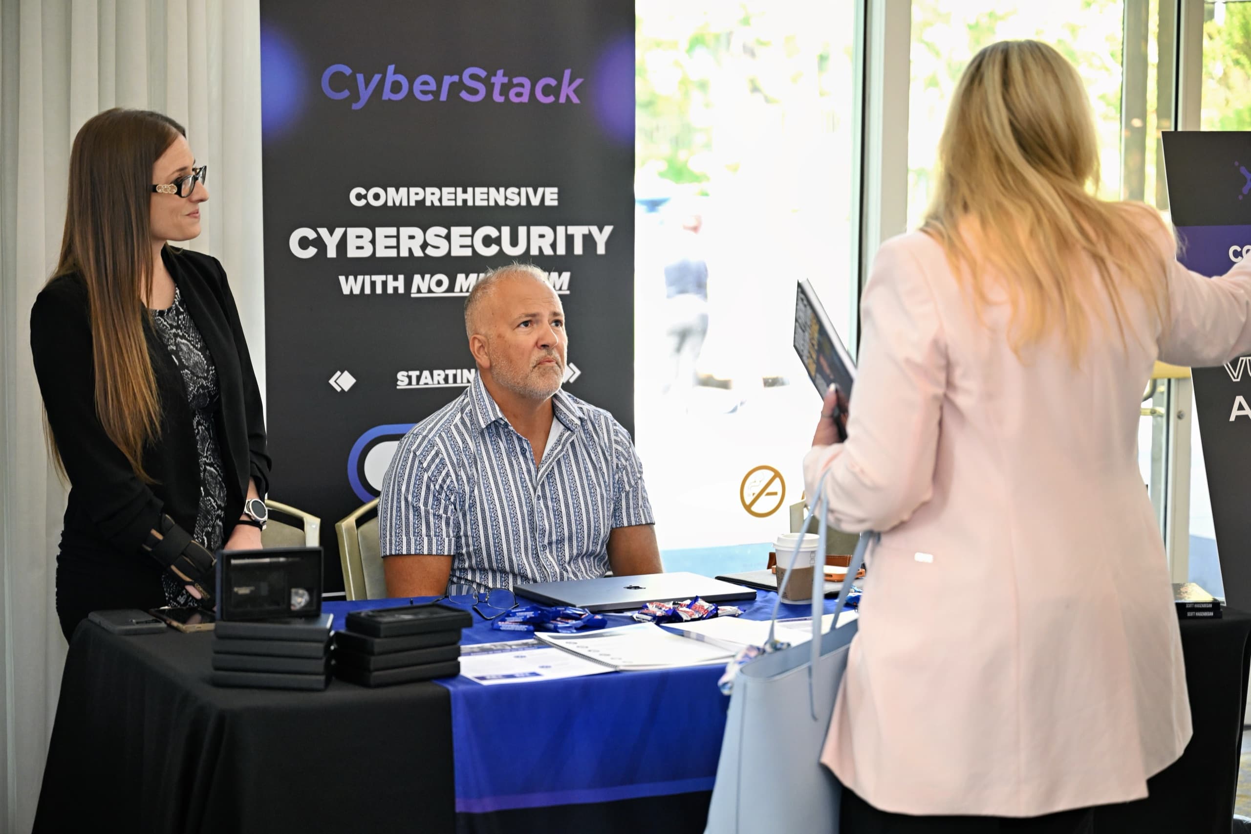 Conference sponsor booth and attendees — expo floor photography Central Valley